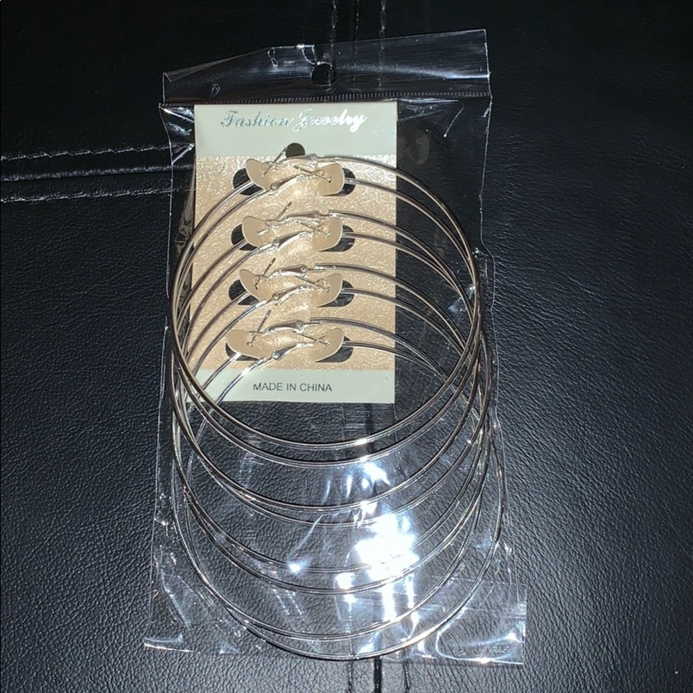 4 pairs of silver hoop earrings.